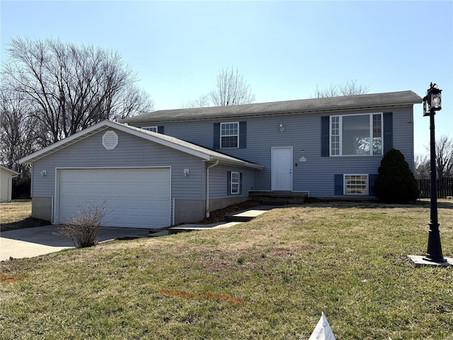 bi-level home featuring a garage, a front yard, and driveway