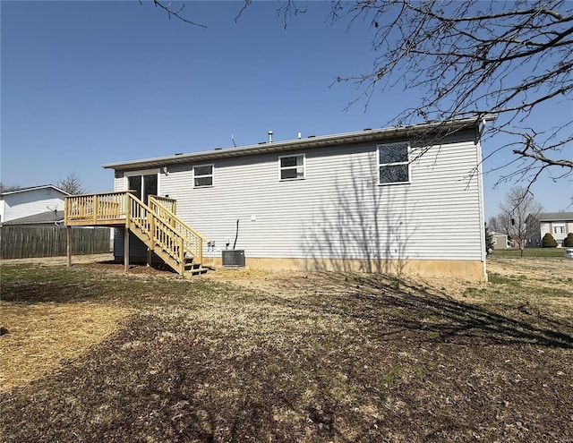 back of property with stairs and a deck