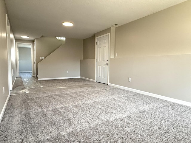 carpeted empty room with visible vents and baseboards