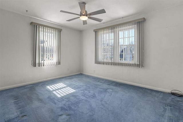 unfurnished room featuring baseboards, a ceiling fan, and carpet