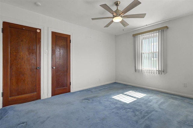 unfurnished bedroom with baseboards, carpet, and a ceiling fan