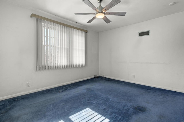 spare room with visible vents, ceiling fan, baseboards, and carpet