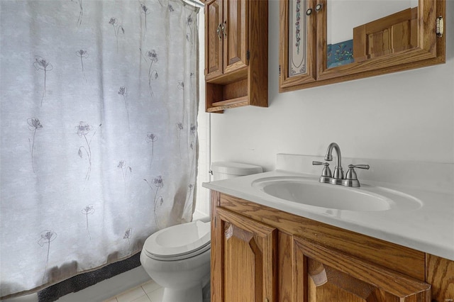 full bath featuring vanity, tile patterned floors, and toilet