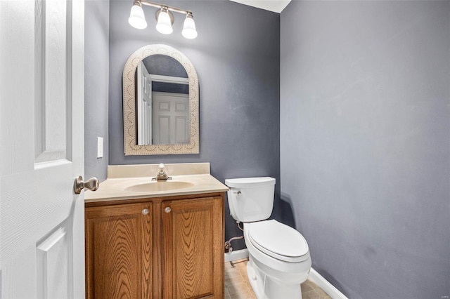 bathroom with tile patterned floors, baseboards, toilet, and vanity