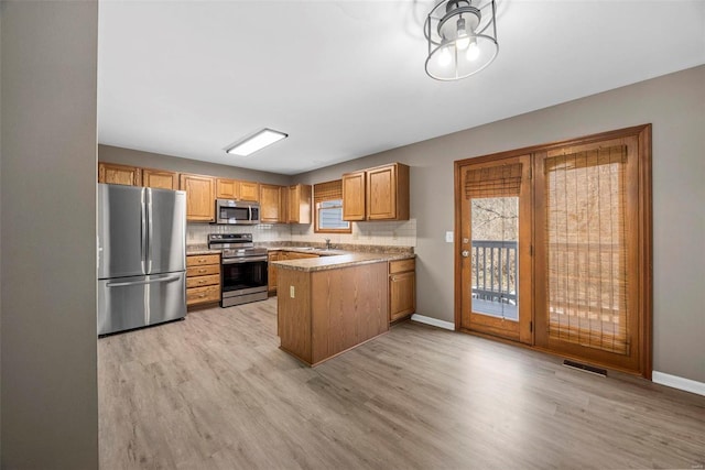 kitchen with tasteful backsplash, visible vents, appliances with stainless steel finishes, and a sink