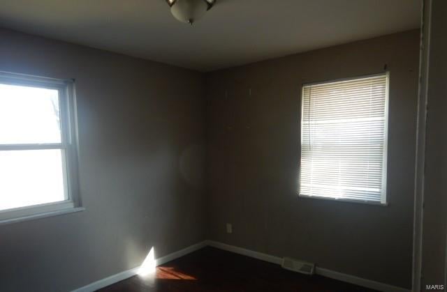 spare room with baseboards and visible vents