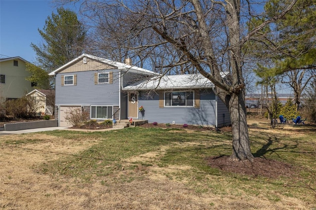 tri-level home featuring a garage, a front lawn, and driveway