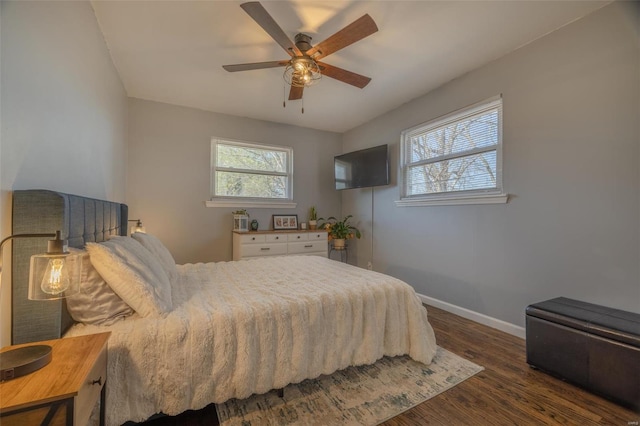 bedroom featuring ceiling fan, baseboards, and wood finished floors