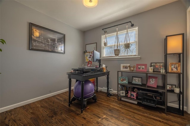 office space featuring baseboards and wood finished floors