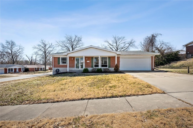 view of front of home featuring a front yard, brick siding, concrete driveway, and an attached garage