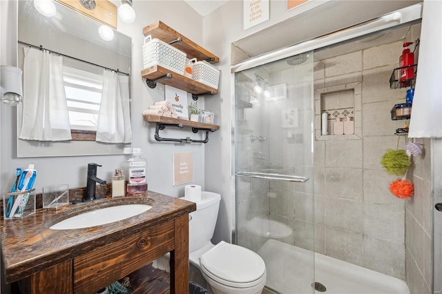 full bathroom with vanity, toilet, and a stall shower