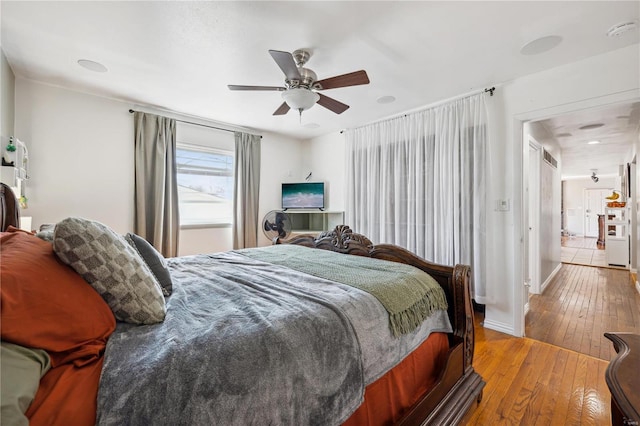 bedroom with hardwood / wood-style flooring, baseboards, and ceiling fan