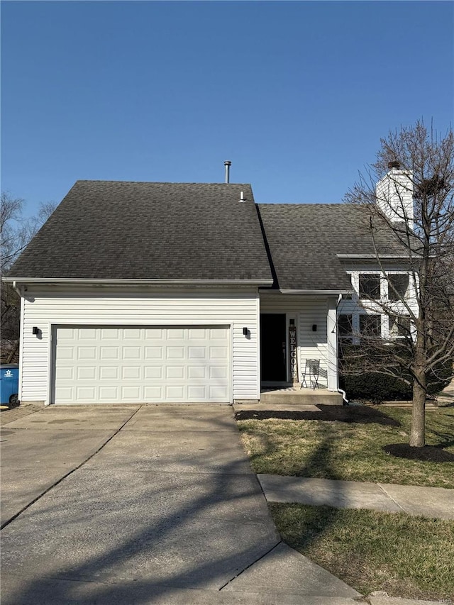 view of front of house with an attached garage, roof with shingles, and driveway