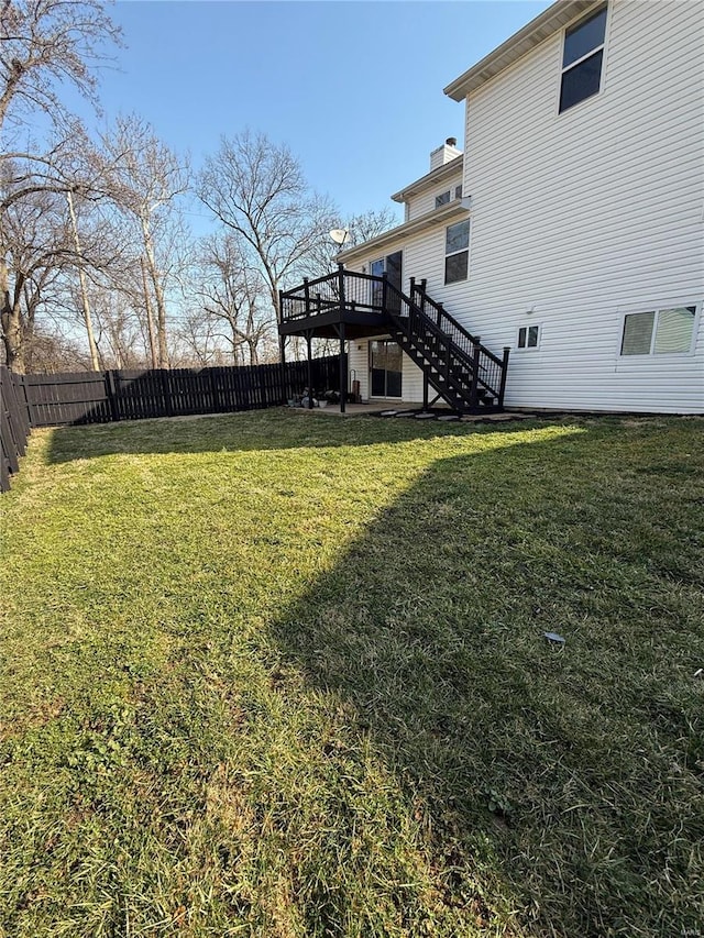 view of yard with stairway, a deck, and a fenced backyard