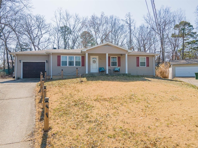 single story home featuring concrete driveway, a porch, a garage, and a front yard