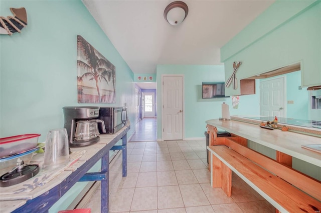 kitchen with light tile patterned floors and baseboards