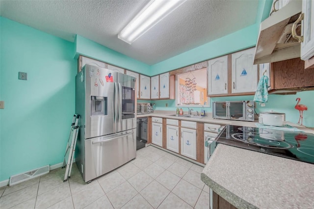 kitchen featuring visible vents, stainless steel fridge with ice dispenser, dishwasher, a textured ceiling, and a sink