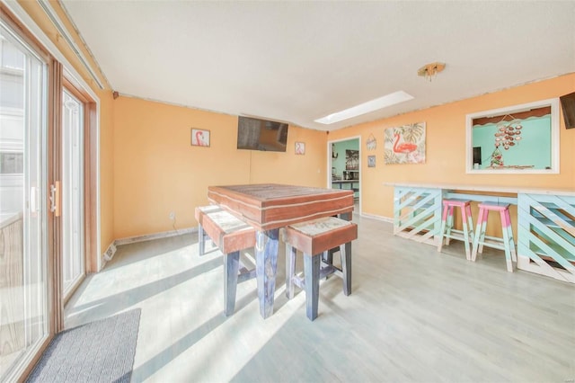 game room with baseboards and wood finished floors