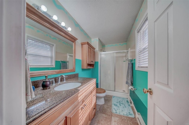 bathroom with vanity, toilet, a stall shower, and a textured ceiling