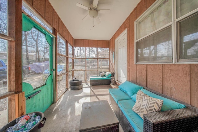 unfurnished sunroom featuring a ceiling fan