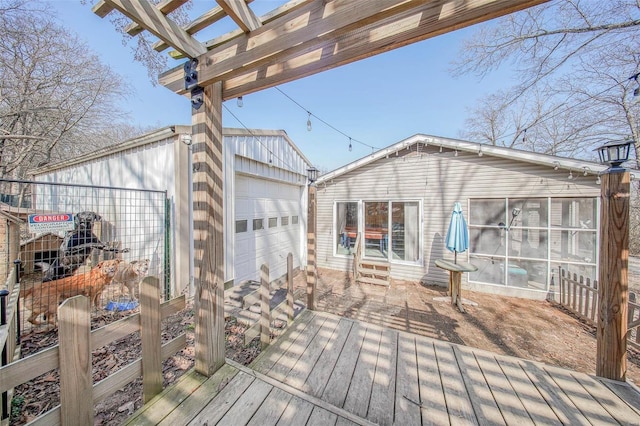 deck with an outdoor structure and a garage