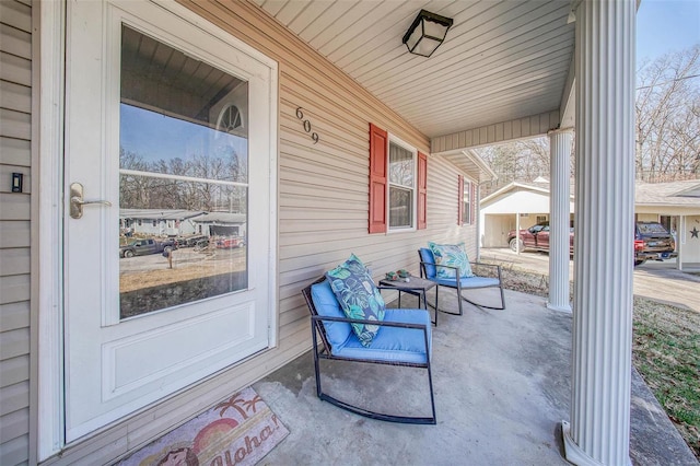 view of patio / terrace with an outbuilding and covered porch