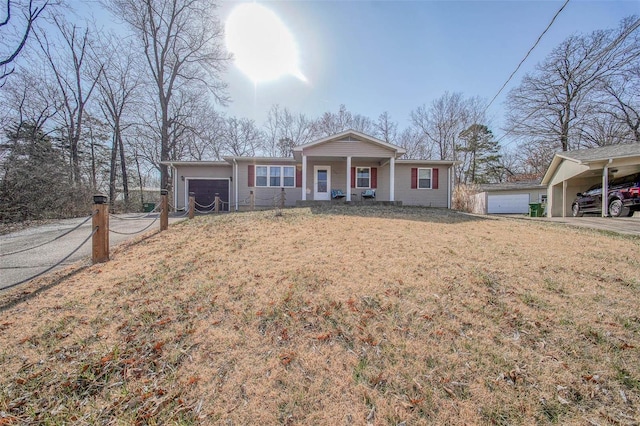 view of front facade with a front lawn, a porch, a garage, and driveway