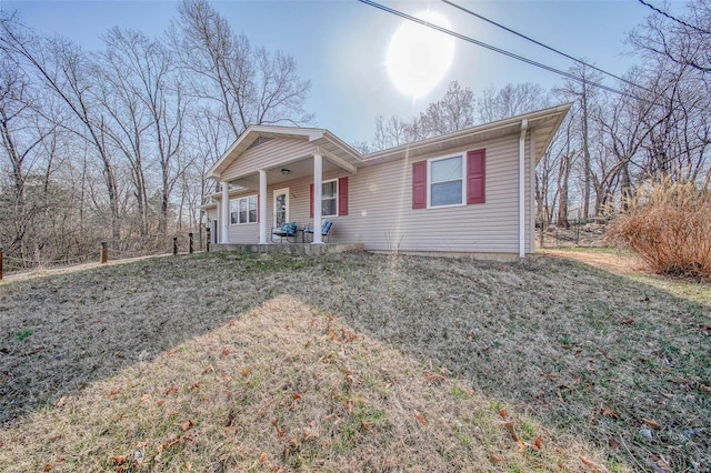 view of front of property with a porch and a front yard