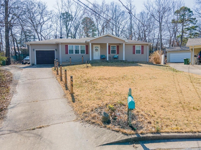 single story home featuring concrete driveway, a garage, and a front yard