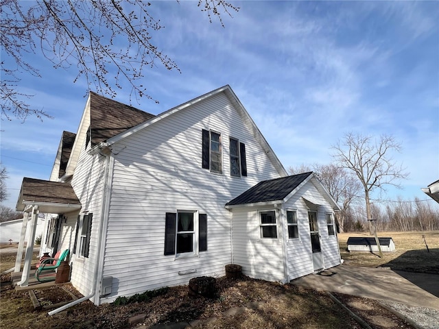 view of home's exterior featuring roof with shingles