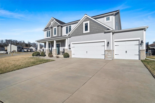 craftsman house with a front lawn, covered porch, board and batten siding, and driveway