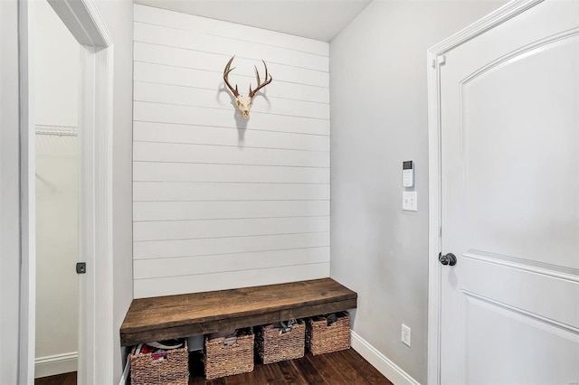 mudroom featuring baseboards and dark wood-style flooring