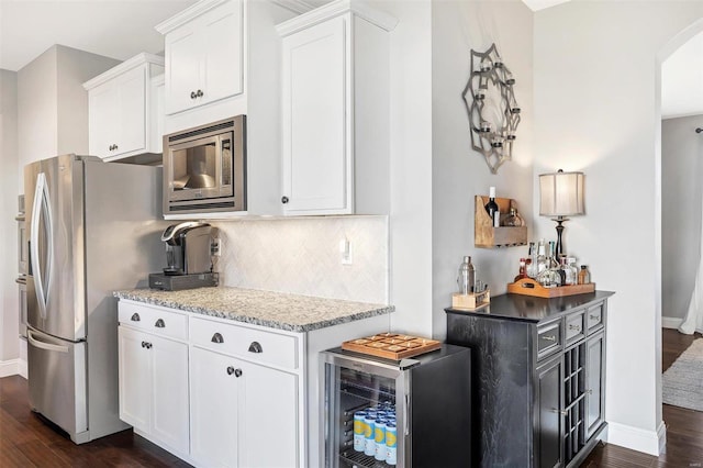 kitchen featuring stainless steel appliances, wine cooler, decorative backsplash, and dark wood-style flooring