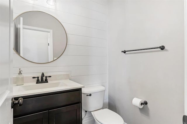 half bathroom with toilet and vanity