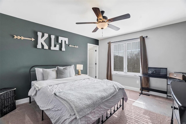 carpeted bedroom featuring baseboards and ceiling fan