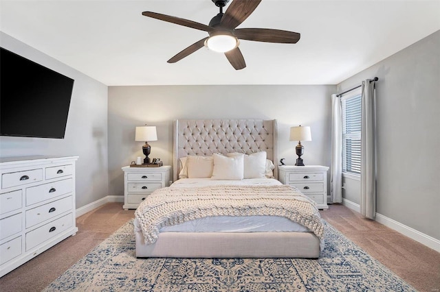 bedroom with light colored carpet, a ceiling fan, and baseboards