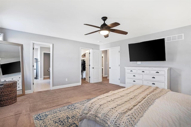 bedroom with baseboards, visible vents, and light carpet