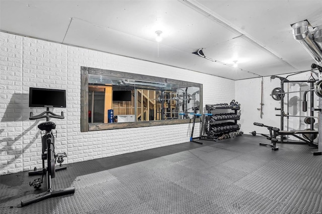 exercise area featuring brick wall