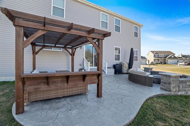 view of patio / terrace with area for grilling, a pergola, and an outdoor living space with a fire pit