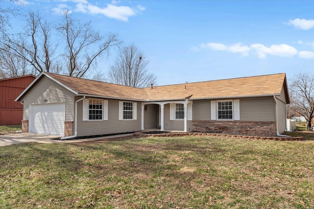 ranch-style home featuring brick siding, an attached garage, driveway, and a front lawn