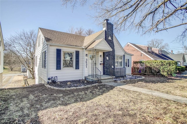 bungalow-style house with a chimney and roof with shingles