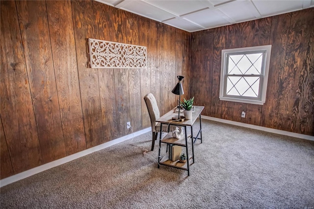 home office with carpet flooring, baseboards, and wooden walls