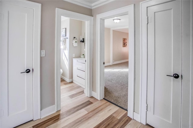 corridor with baseboards and light wood-type flooring