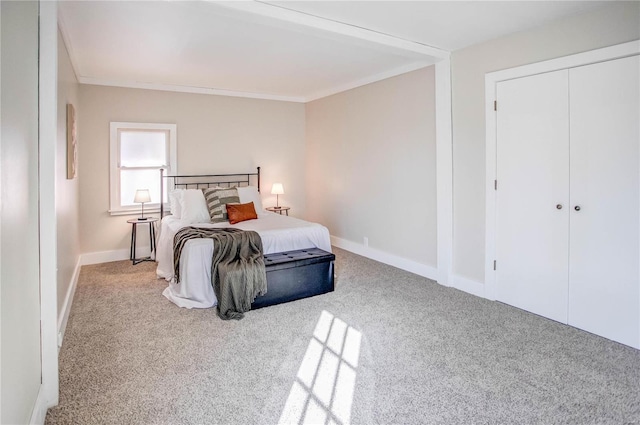 bedroom featuring baseboards, ornamental molding, and carpet flooring