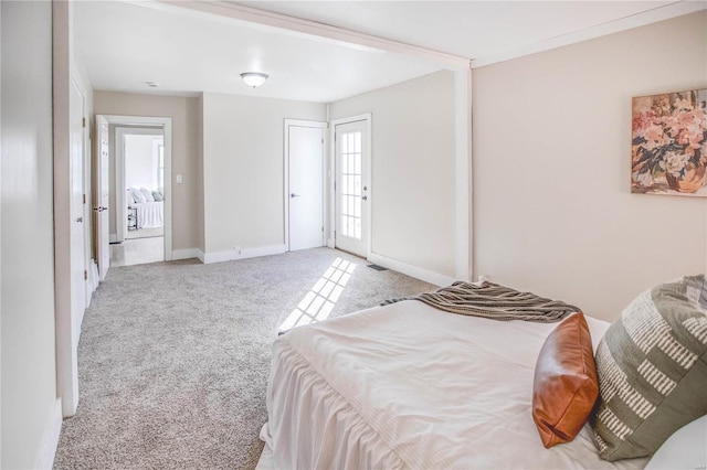 bedroom with baseboards and light colored carpet