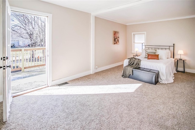 carpeted bedroom with visible vents, multiple windows, baseboards, and access to outside