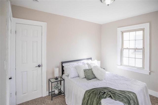 carpeted bedroom with baseboards