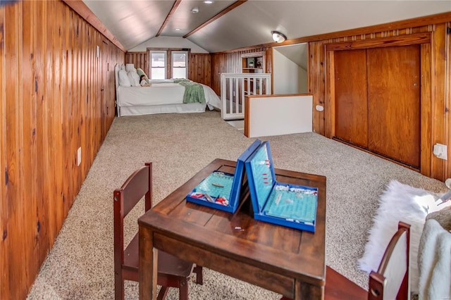 bedroom featuring wood walls, carpet flooring, and vaulted ceiling