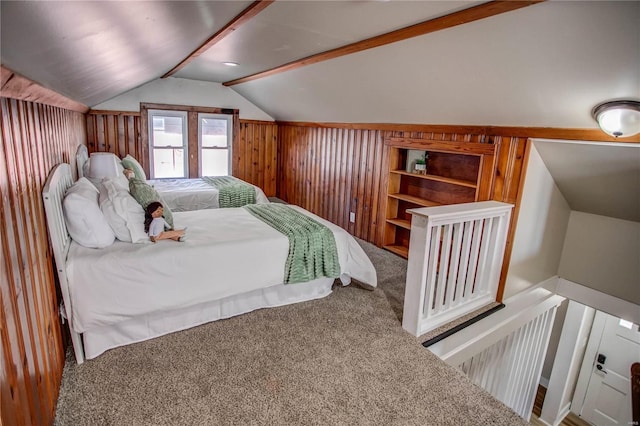 bedroom featuring lofted ceiling, wood walls, and carpet flooring