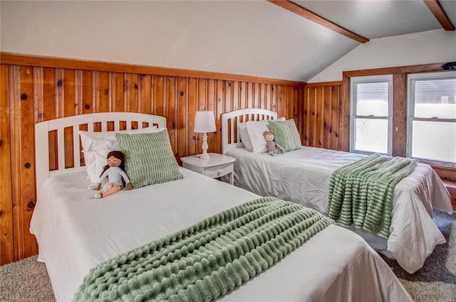 bedroom featuring wooden walls and vaulted ceiling with beams